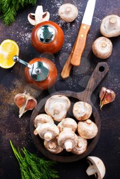 mushrooms on wooden plate and on a table