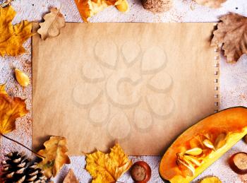 autumn background, dry leaves and paper on a table, stock photo