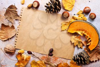 autumn background, dry leaves and paper on a table, stock photo