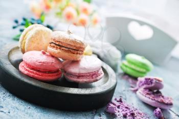 macaroons on wooden board and on a table