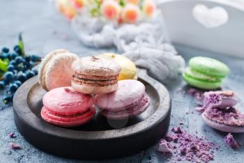 macaroons on wooden board and on a table