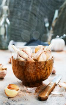 garlic in wooden bowl and on a table