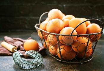raw eggs in metal basket and on a table