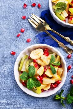 fruit salad in bowls on a table, portions of fresh salad