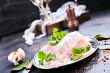 raw fish fillet with aroma spice on plate