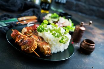 kebab with boiled rice on plate, stock photo