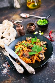  Vegan dish. Fried mushrooms and cabbage in the frying pan. European cuisine.