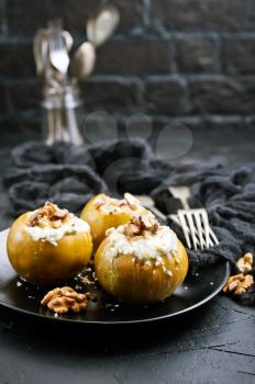baked apples with nuts and honey, desert on plate