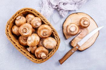 basket of champignon mushrooms on old  table