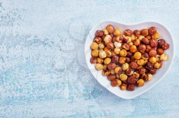 hazel nuts in white bowl, dry hazelnuts