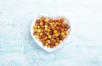 hazel nuts in white bowl, dry hazelnuts