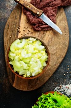  Cutting celery stalks in bowl. diet food