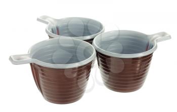 Group of three empty disposable plastic brown coffee cups isolated on white background
