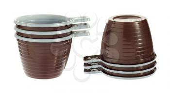 Pile of empty disposable plastic brown coffee cups isolated on white background