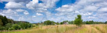 Beautiful summer panoramic view of the village and meadow.