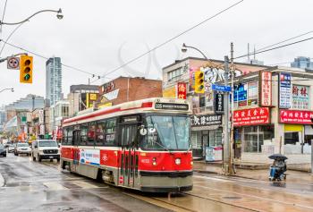 Toronto, Canada - May 2, 2017: Old streetcar in Chinatown of Toronto. The Toronto streetcar system is the largest and the busiest light-rail system in North America
