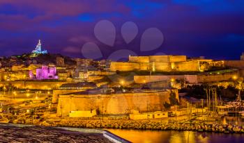 Night view of Fort St. Nicolas and Notre-Dame-de-la-Garde in Marseille, France