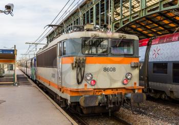 NARBONNE, FRANCE - JANUARY 06: Regional train hauled by electric locomotive at Narbonne station on January 6, 2014. SNCF operates 27 locomotive of class BB 8500