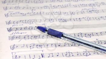 Music sheet with musical notes and blue pen