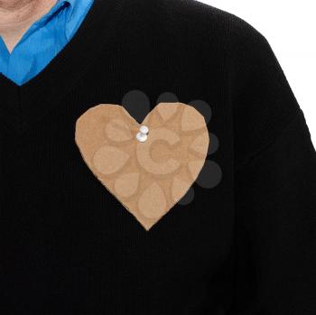 Roughly carved cardboard heart pinned to the clothes of a man