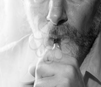 Black-white portrait of a smoking man on a light background