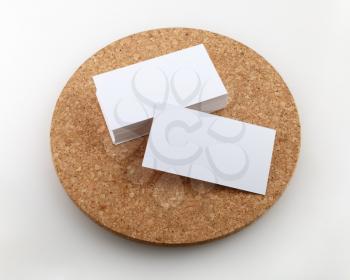 Blank business cards on a round cork base. Clipping path