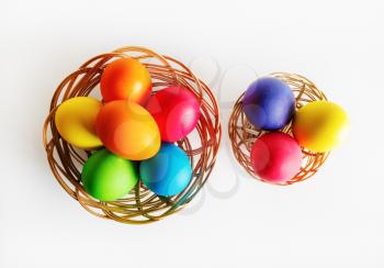 Bright multi-colored easter eggs in two baskets. Colorful easter eggs. Top view.