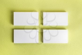 Blank business cards on green background. Template for ID. Top view.