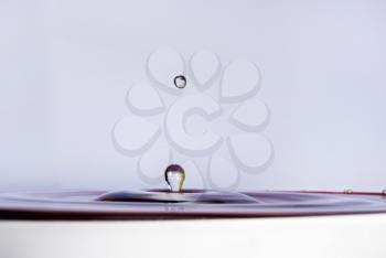 A drop of water falling into the water. Shallow depth of field. Selective focus.