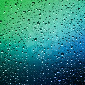 Raindrops on a window pane. Droplets of water on the glass. Water drops background.