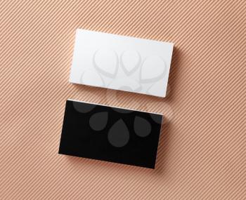 Blank black and white business cards on a color background. Top view.