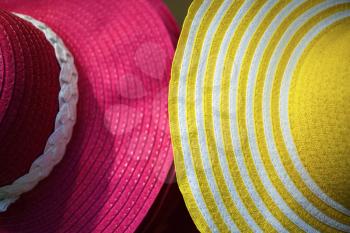 Close-up of two female hats with a wide brim. Shallow depth of field. Selective focus.
