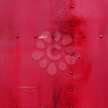 Riveted red metal. Abstract painted matte red metal background texture with rivets. Red metal background 