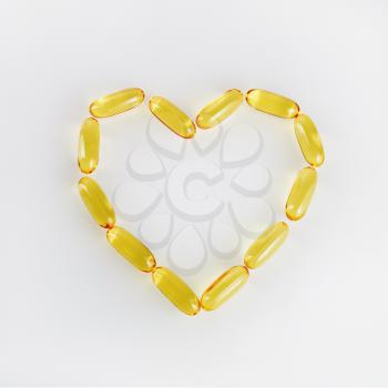 Capsules of heart shaped fish oil. Vitamins for health promotion. Concept photo. 
