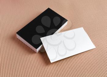 Several black and white business cards on color background.