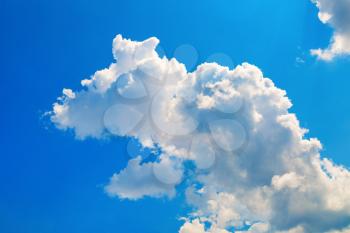 Blue sky with white cumulus cloud. Bright sunny summer day