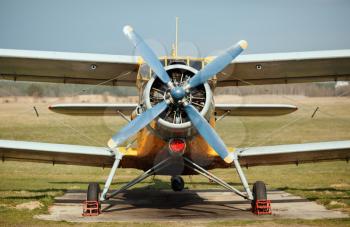 Airplane with blue propeller. Old retro plane close-up. Front view, with the side of the fuselage.