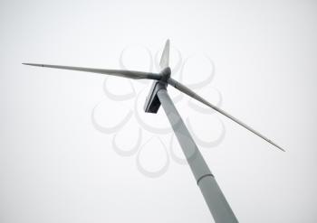 Windmill on a cloudy day. Windmill for electric power production. Renewable electric energy.