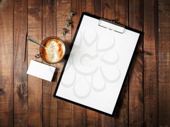 Photo of blank stationery on vintage wooden table background. Blank corporate identity template. Blank branding mock-up. Mockup for design portfolios. Top view.