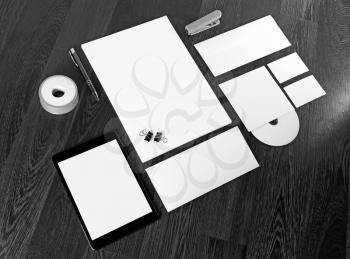 Photo of blank stationery and corporate identity template on dark wooden background. Blank template for design presentations and portfolios.