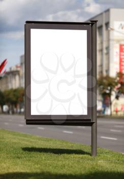 Blank vertical billboard on the street. Clipping path. Shallow depth of field.