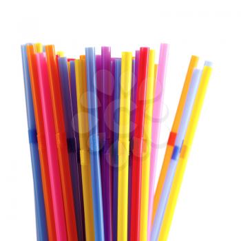Multicolored plastic straws for drinking on a white background. Shallow depth of field. 