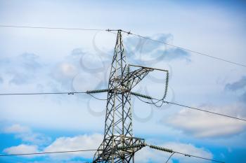 High voltage tower. Electricity pylon with blue sky background.