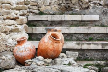 Antique ceramic pots. Old clay vases outdoors. Archaeological still life. Selective focus.