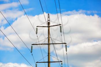 Old power lines. Electricity transmission pylon against the blue sky. High voltage tower.