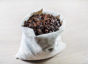 Coffee beans in a canvas bag. Selective focus.
