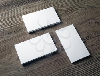 Three stacks of blank business cards on wood background. Template for your design. Template for ID. Responsive design mockup.