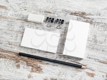 Blank stationery template for placing your design. Business cards, pencil, eraser, badge and sharpener on vintage wood table background. Corporate identity mock-up. ID mockup. Mock up for branding ide
