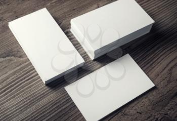 Stacks of blank business cards on wooden table background. Template for branding identity.
