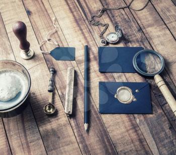 Photo of vintage stationery elements on wood table background. Branding template. Mock-up for your design.